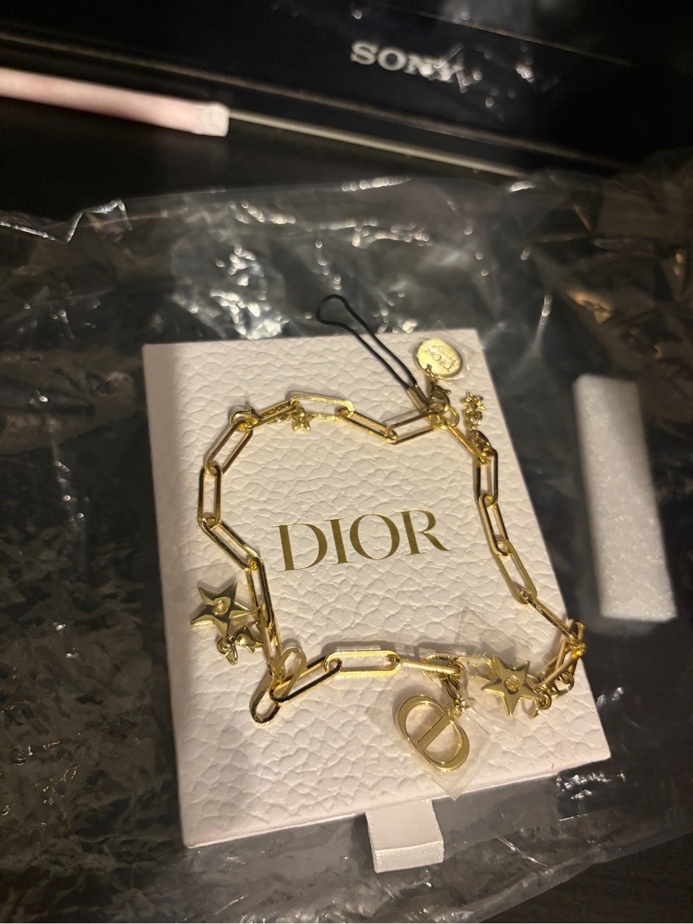 Dior gold phone charm or bracelet